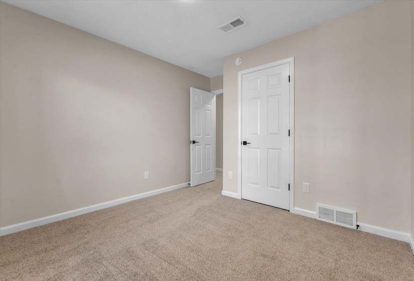 Spare room with baseboards and carpet floors
