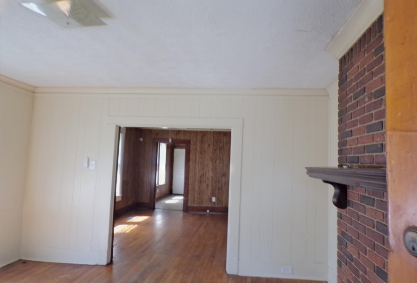 Unfurnished room featuring dark wood finished floors and a textured ceiling
