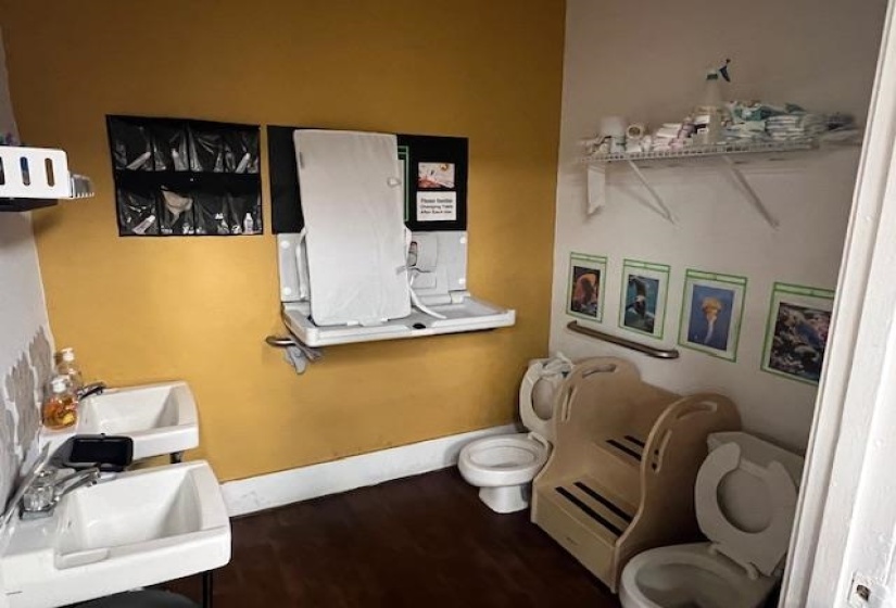 Half bathroom featuring dark wood-style floors and vanity