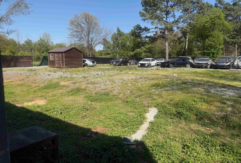 View of yard with a storage unit