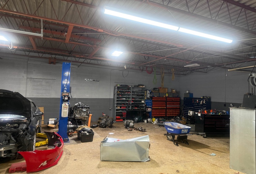Garage featuring concrete block wall