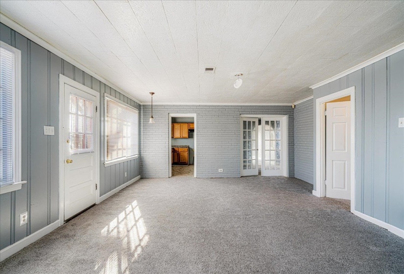 Unfurnished bedroom with multiple windows, carpet, and ornamental molding