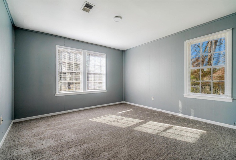 Empty room with carpet and baseboards