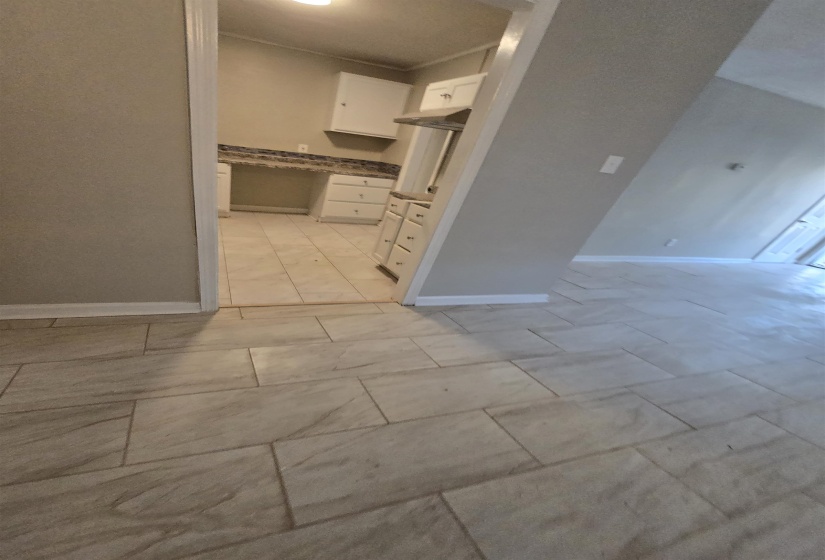 Kitchen with white cabinetry and baseboards