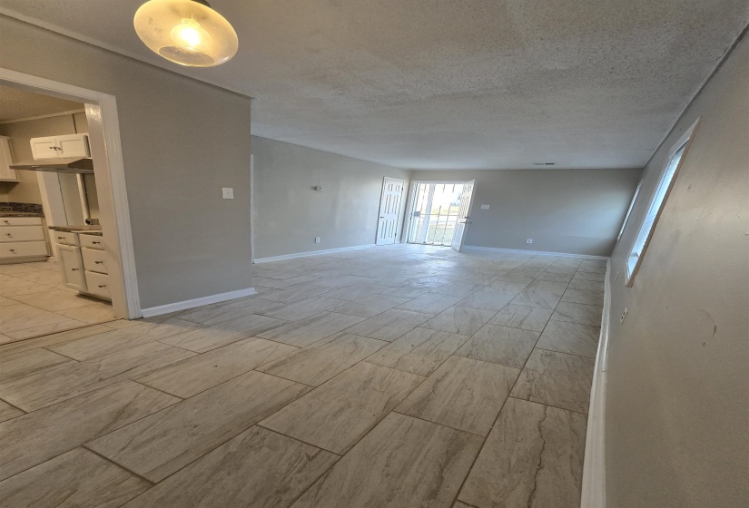Spare room with baseboards and a textured ceiling