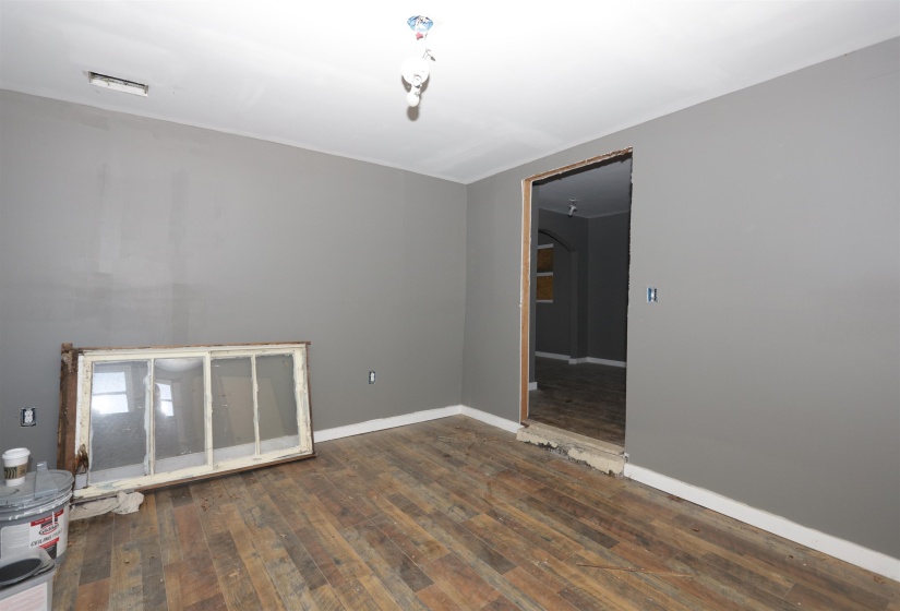 Spare room with dark wood finished floors and arched walkways