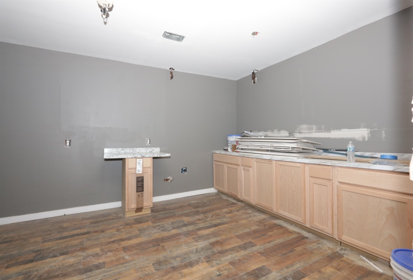 Kitchen featuring light wood finish cabinets, dark wood finished floors, and light countertops