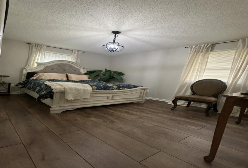 Bedroom featuring hardwood / wood-style floors and a textured ceiling