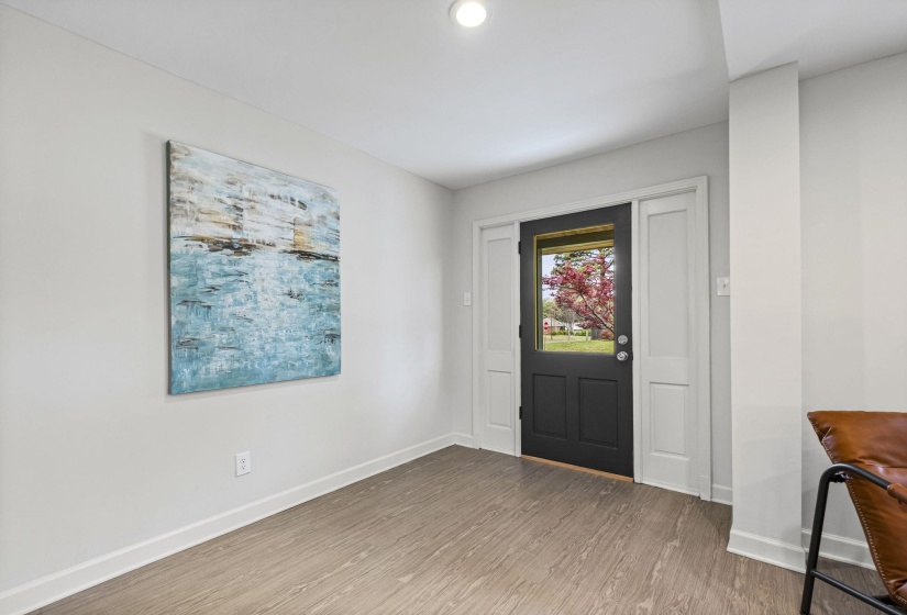 Foyer featuring wood finished floors and baseboards