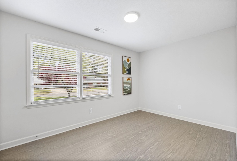 Unfurnished room featuring baseboards and wood finished floors