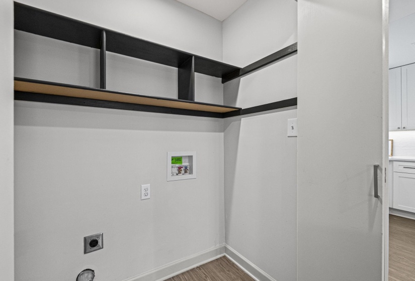 Laundry area featuring wood finished floors, electric dryer hookup, and washer hookup