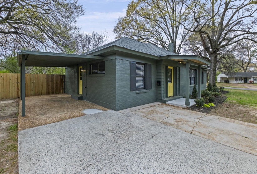 View of front of home featuring brick siding and an attached carport
