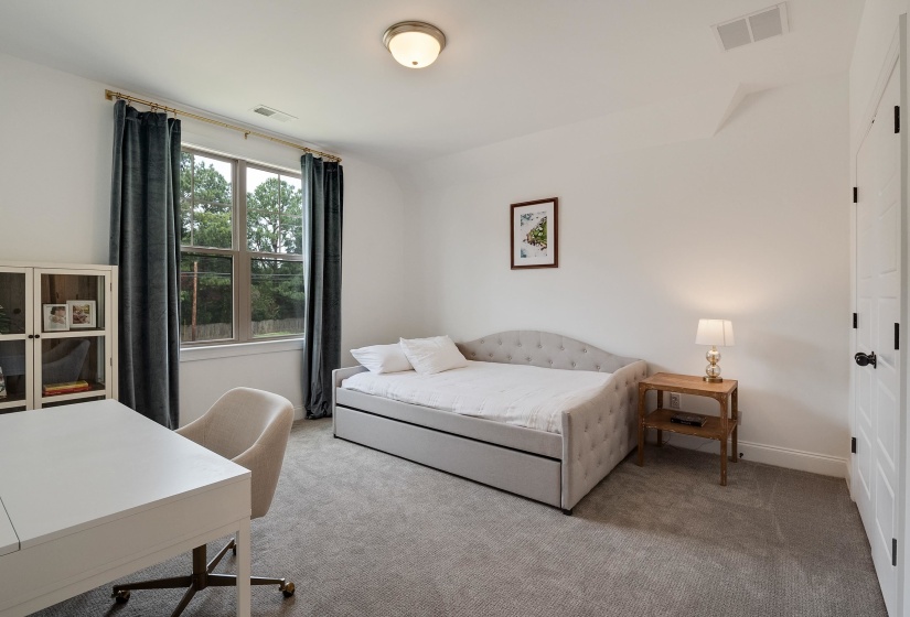 Bedroom with light colored carpet