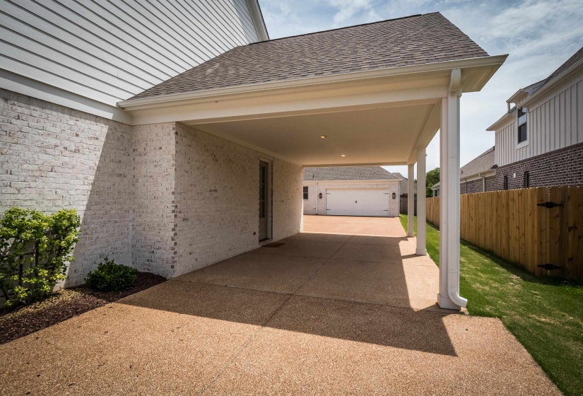 View of parking with concrete driveway