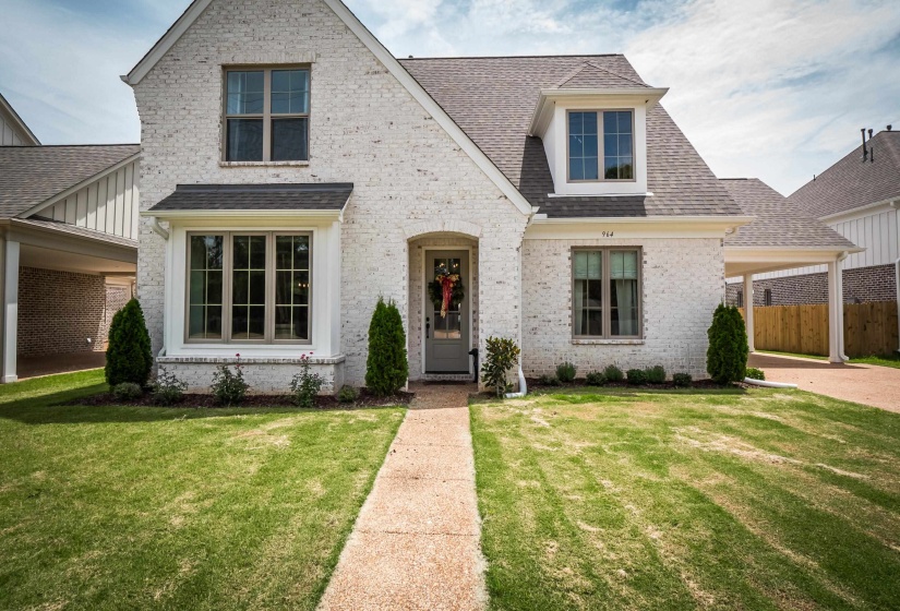 View of front of house featuring roof with shingles and brick siding