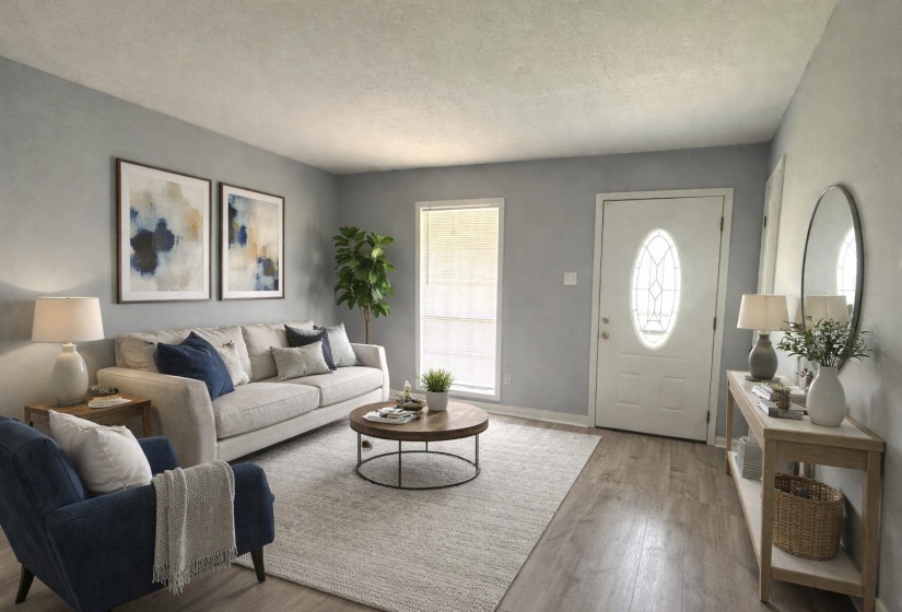 Living room with wood finished floors and a textured ceiling