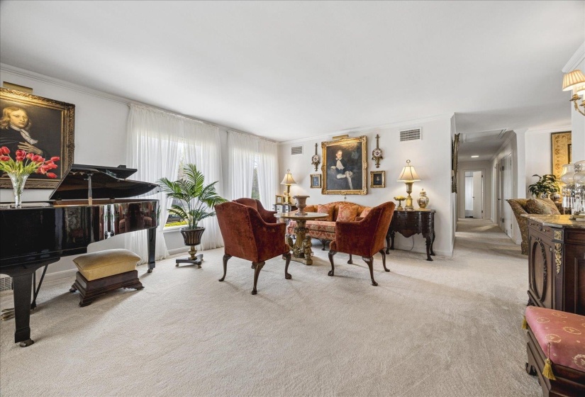 Living area with light carpet and crown molding