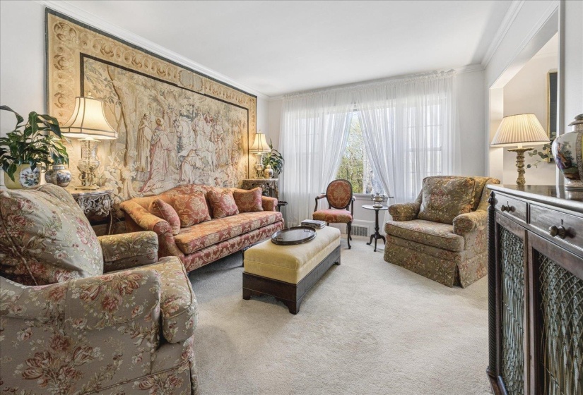 Living room featuring ornamental molding and light colored carpet