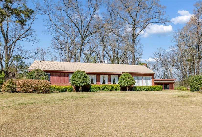 Ranch-style home with a front yard and a metal roof