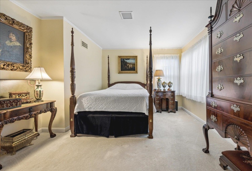 Bedroom featuring light carpet and crown molding