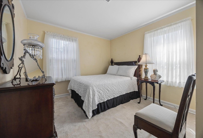Bedroom featuring carpet floors and crown molding