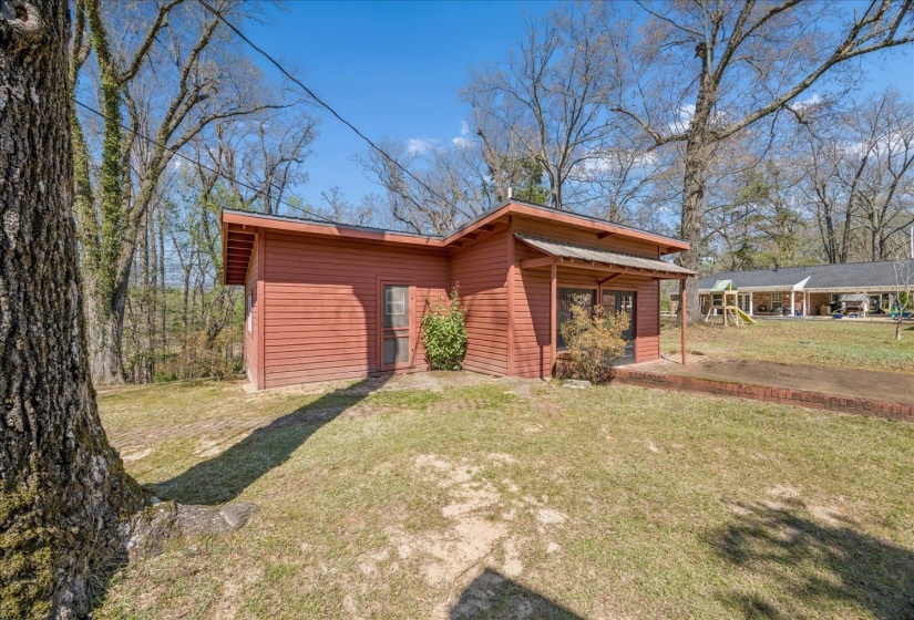 View of side of home featuring a yard