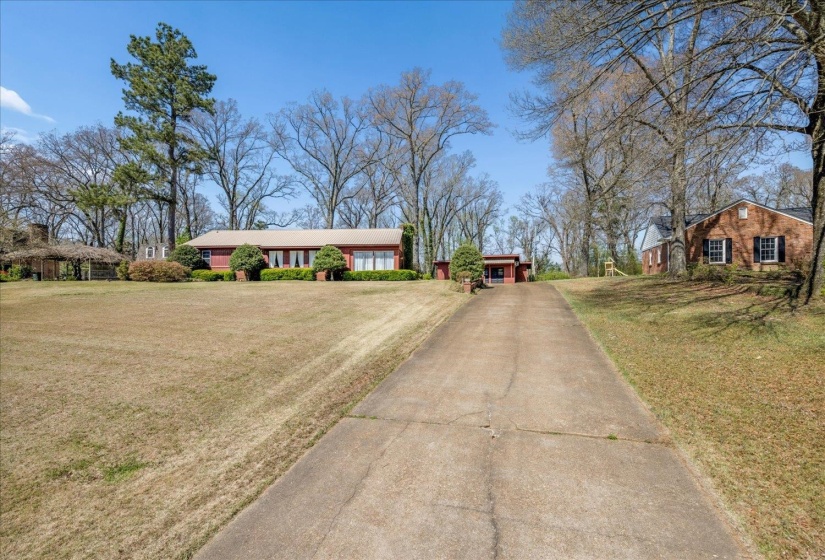 View of front of home with a front yard and concrete driveway