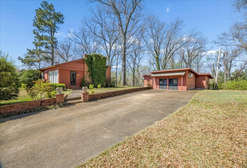 View of home's exterior with concrete driveway and a yard