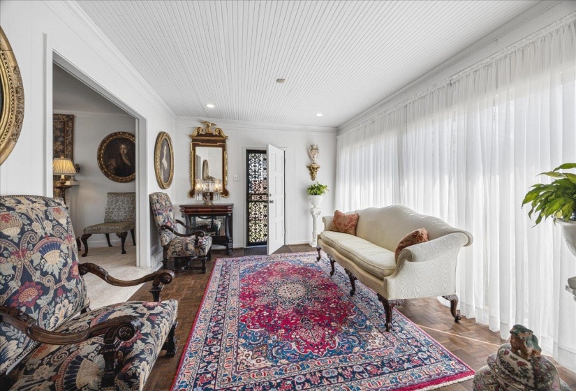 Living area featuring parquet flooring and crown molding