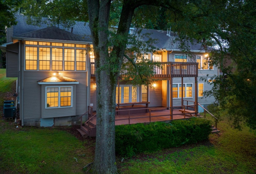 Back of property with a lawn and a wooden deck