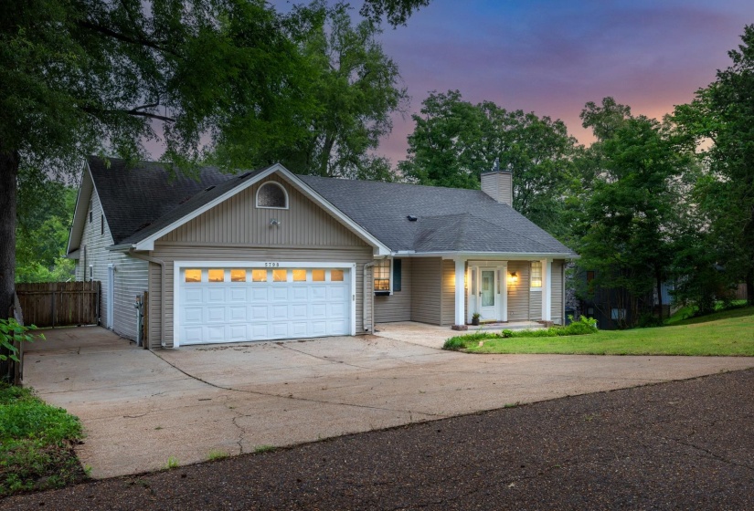 Ranch-style home featuring driveway, roof with shingles, a garage, and a chimney