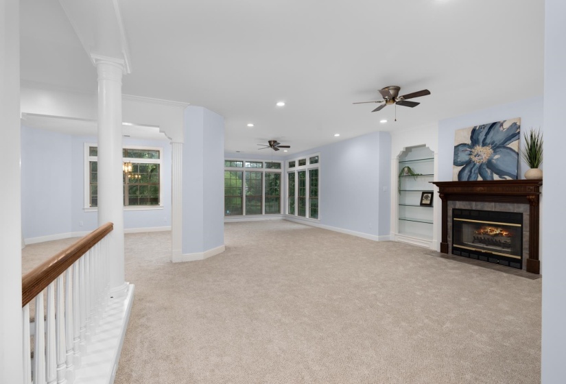 Unfurnished living room with light carpet, a tile fireplace, recessed lighting, and a ceiling fan