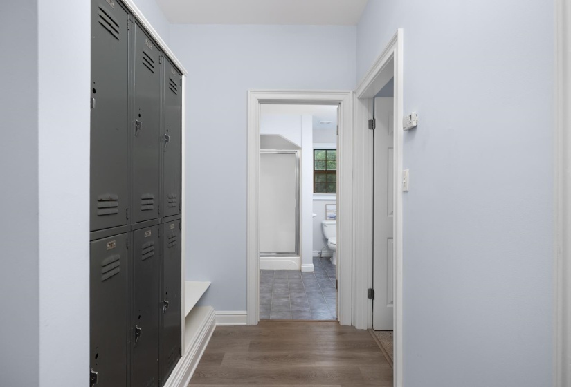 Hallway with dark wood-type flooring and baseboards