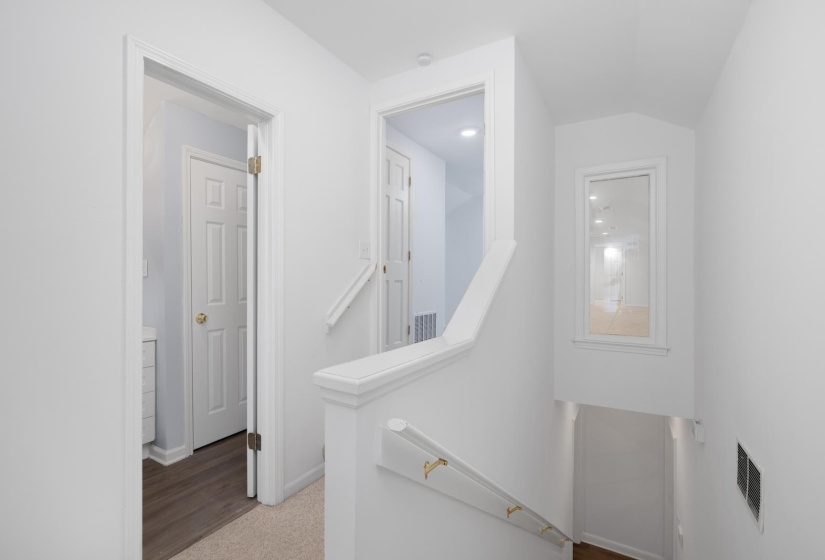 Corridor with an upstairs landing and baseboards
