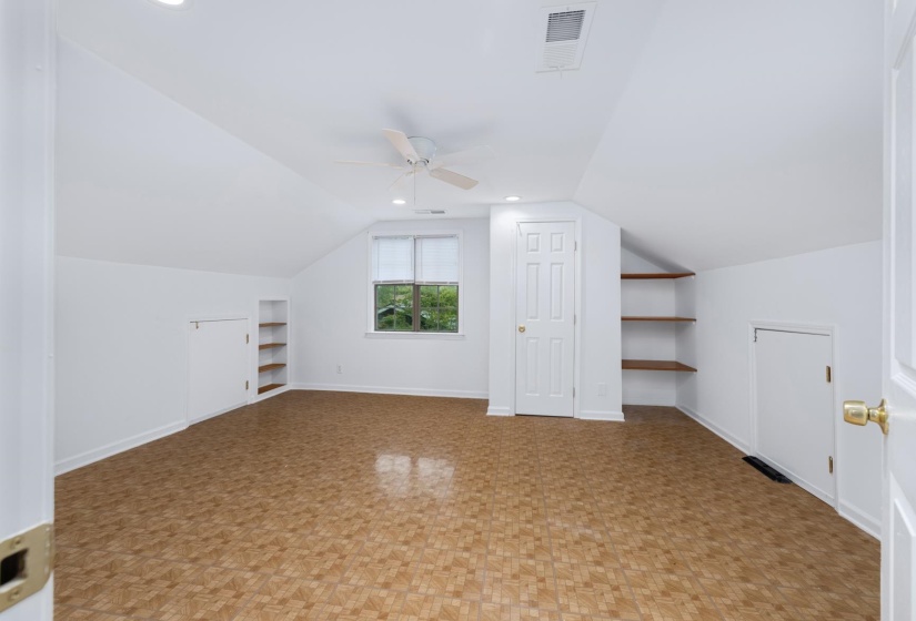 Additional living space with ceiling fan, built in shelves, and recessed lighting