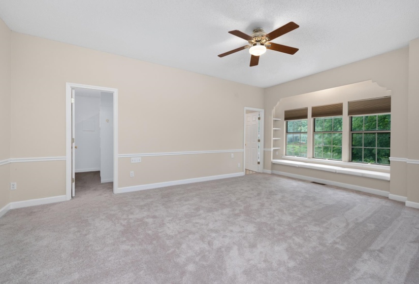 Primary bedroom with a sitting bench and a lakeview