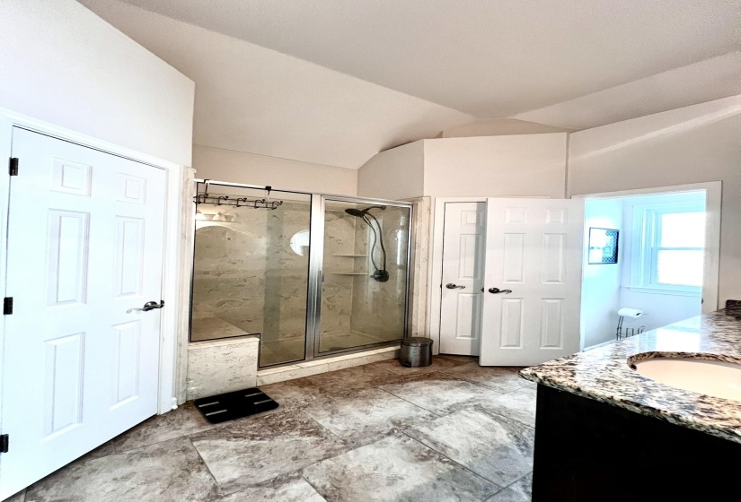 Vaulted ceiling room featuring a separate shower, dbl closets and dbl vanities.