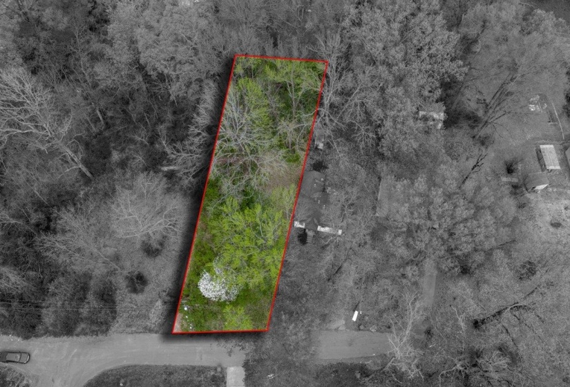 Aerial view of property and surrounding area with property parcel outlined