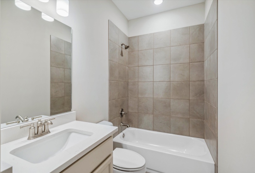 Full bath featuring vanity and bathing tub / shower combination