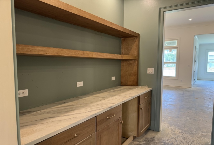 Built-in cabinetry with a light wood finish and brushed nickel hardware