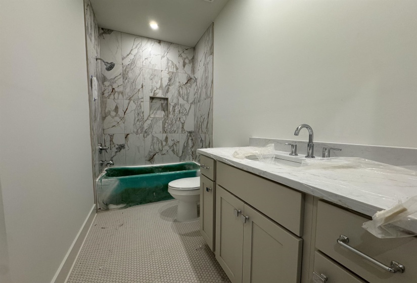 Bathroom featuring a single vanity with light-toned cabinetry and a white countertop