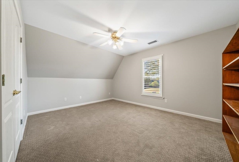 Bonus room with vaulted ceiling, a ceiling fan, and carpet flooring
