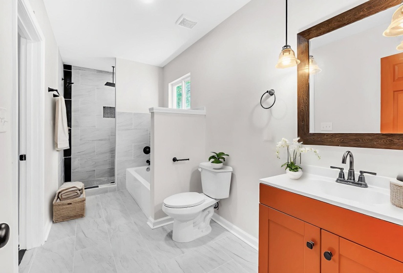 Full bathroom featuring vanity, tiled shower, a bathtub, and light marble finish flooring