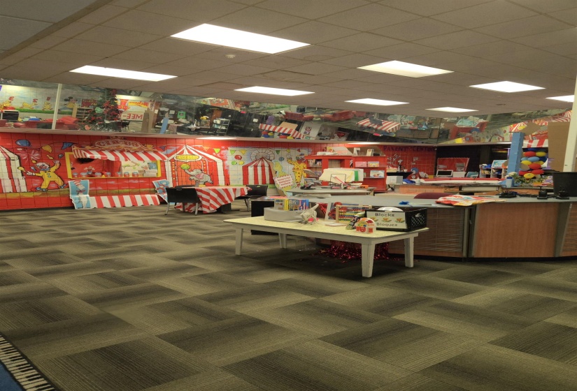 Playroom with a drop ceiling and a workshop area
