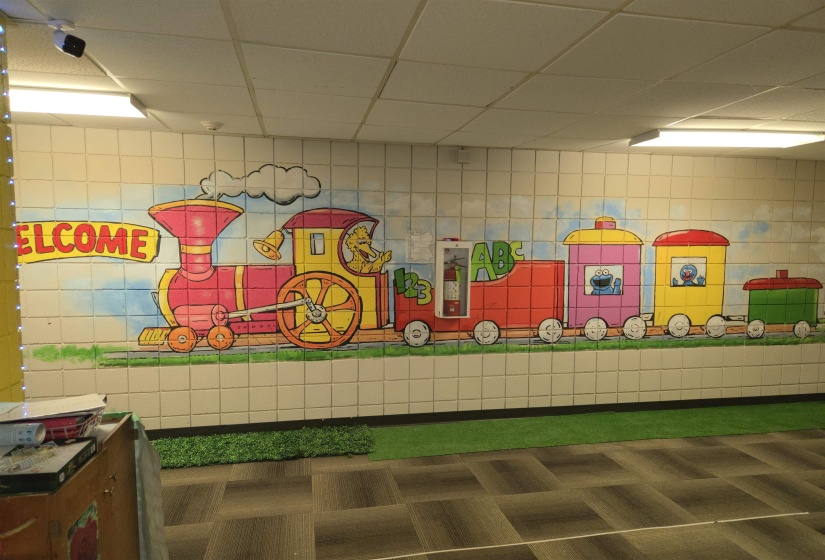 Game room with tile walls and a drop ceiling