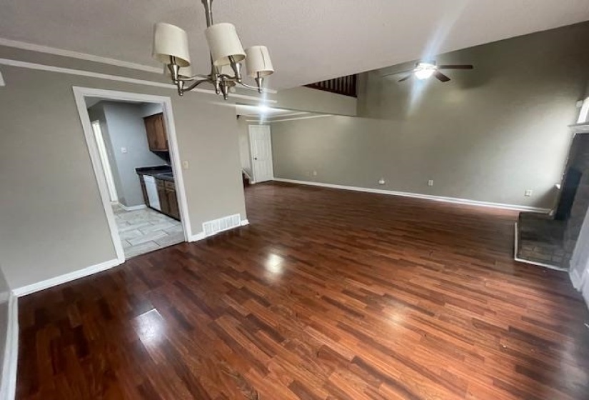 Unfurnished dining area featuring dark wood-style floors, a ceiling fan, and hanging lights
