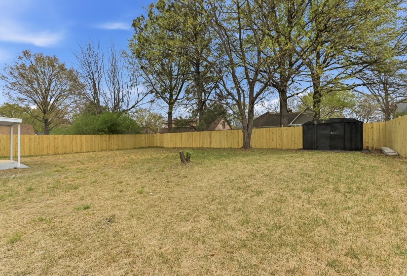 Fenced backyard with a storage unit