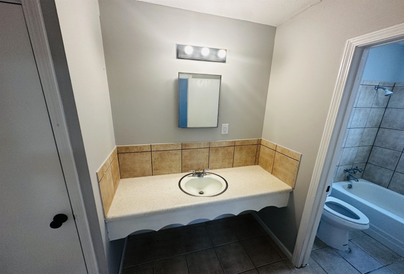 Bathroom with  shower combination, vanity, and tile patterned floors