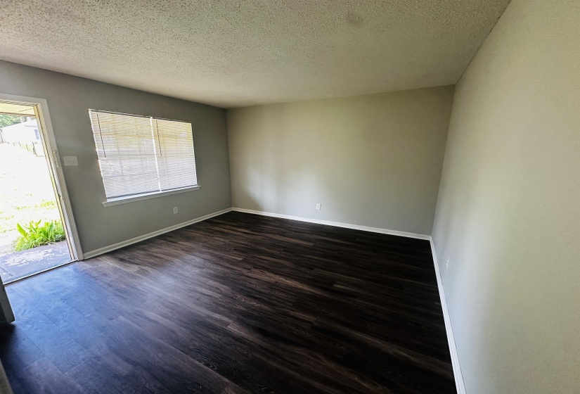 Spare room featuring dark wood finished floors and a textured ceiling