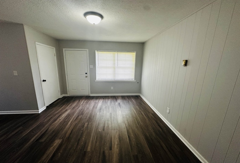 Entryway featuring dark wood-type flooring and a textured ceiling
